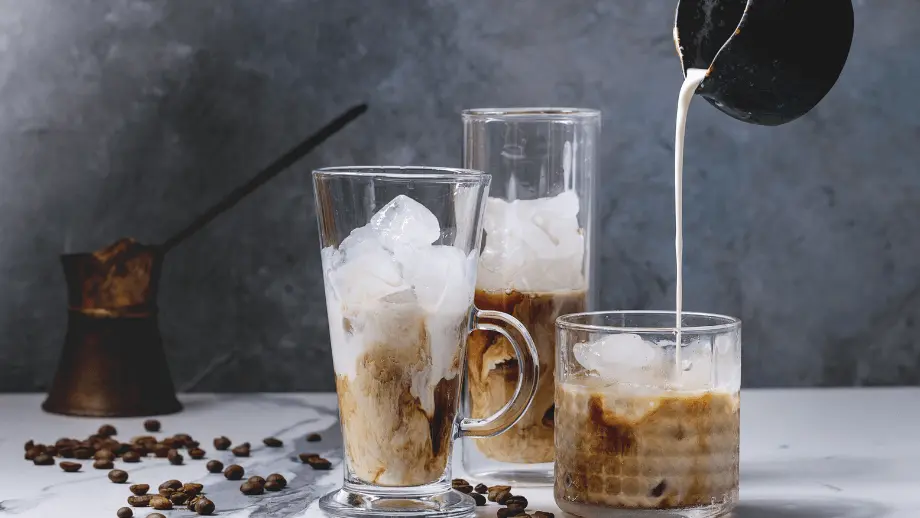 Coffee being poured into glasses.
