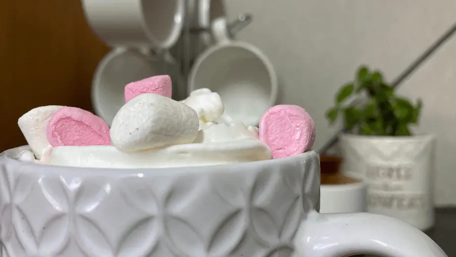 Mini marshmallow condensed milk coffee in a textured mug.