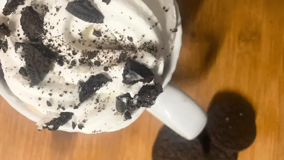 Cookies and cream latte with whipped cream.