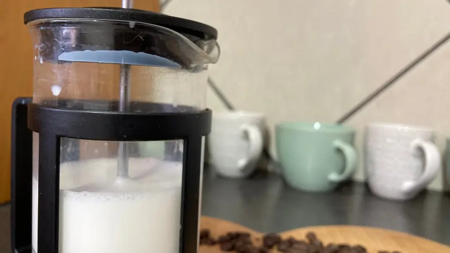 Milk being frothed in French press.