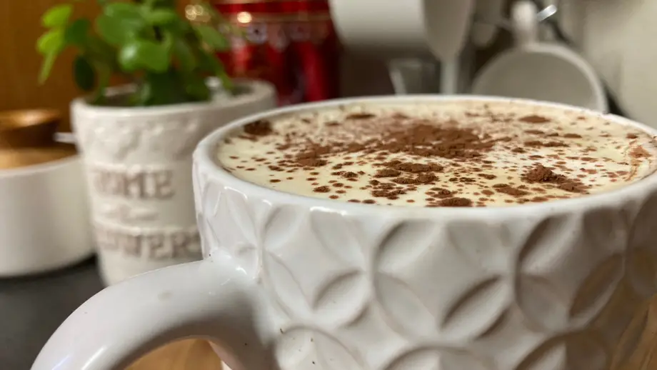 Tiramisu latte in white textured mug.