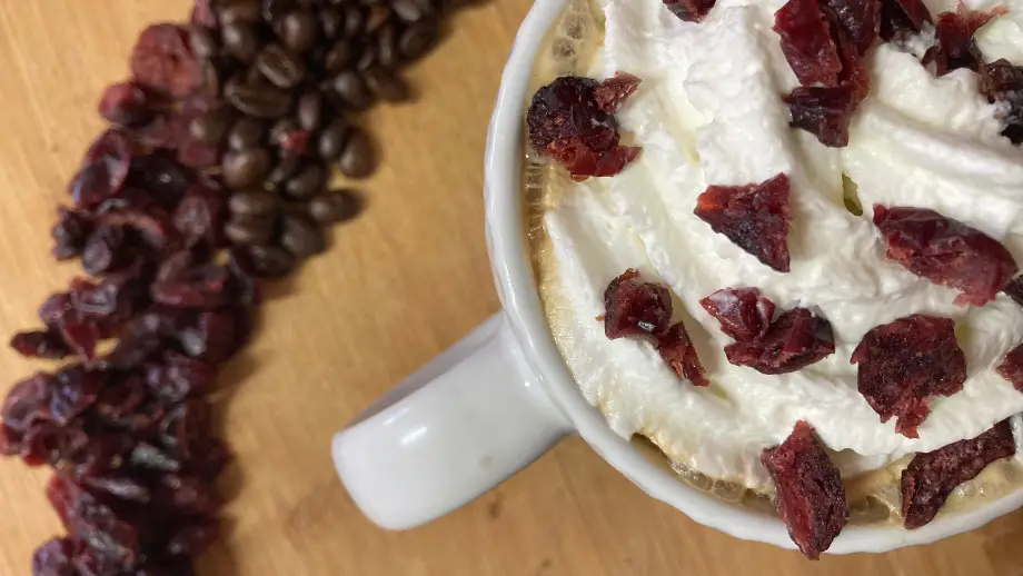 Cranberry latte with whipped cream from above.