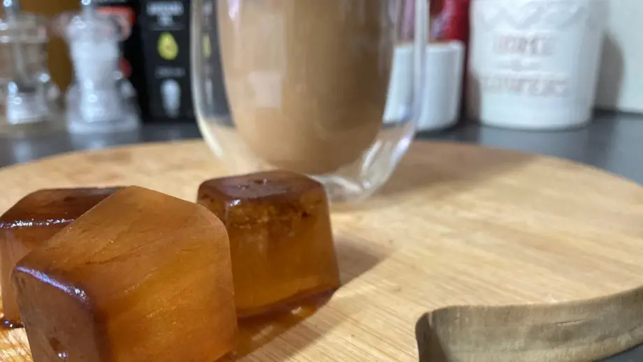 Coffee ice cubes on wooden surface.