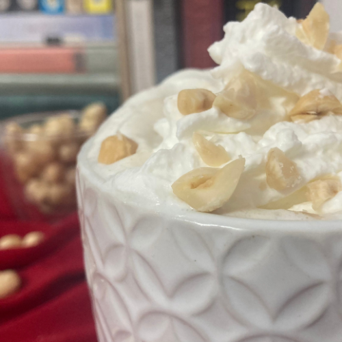 Hazelnut latte in a textured white mug.
