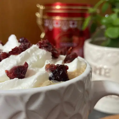 Cranberry latte in white textured mug.
