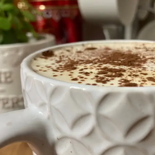 Tiramisu latte in white textured mug.