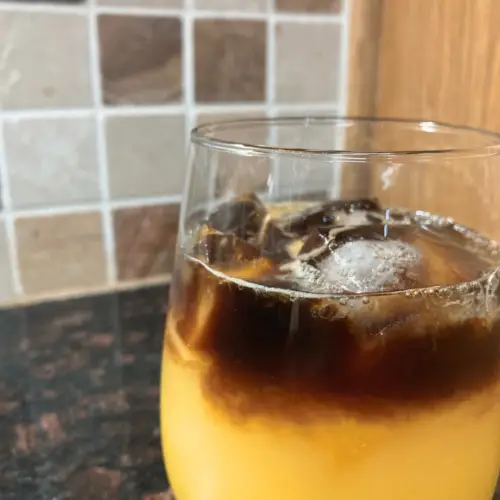 Orange juice and espresso from the side.