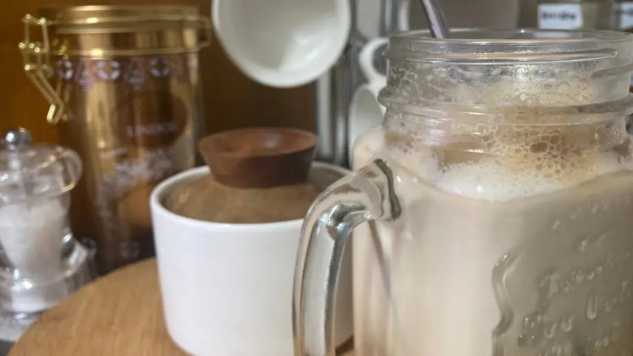 Iced brown sugar shaken espresso in glass jar.
